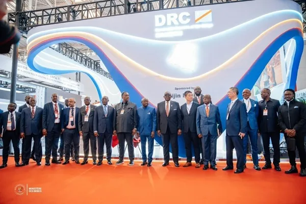 DRC Delegation Poses in Front of the Country Pavilion Sponsored by Zijin Mining