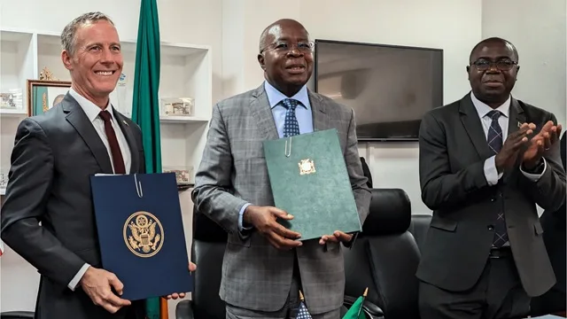 US Chargé d'Affaires Mich Coker and Zambia's Minister of Finance Situmbeko Musokotwane sign the Global Health Cooperation MoU, witnessed by Minister of Health Rama Chilengi